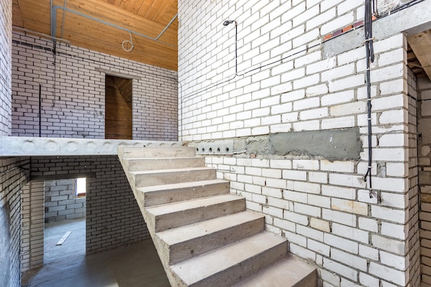 Empty interior in house without repair with white silicate brick walls