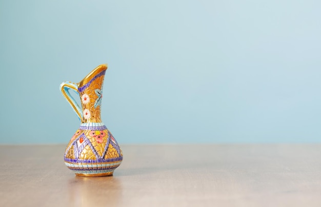 Empty little indian jug on wooden table