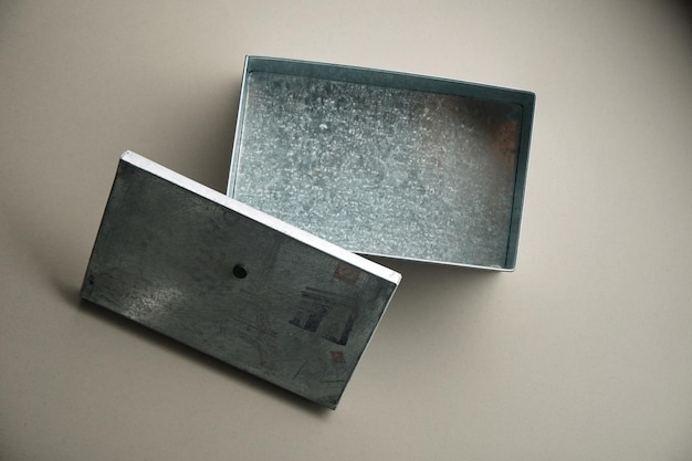 empty metal box against gray background