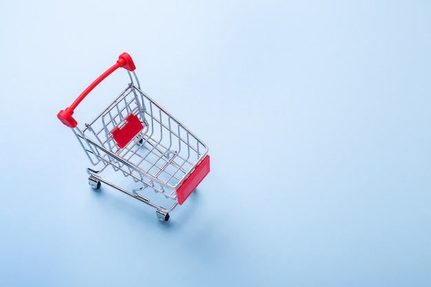 Empty mini trolley cart copy on blue background Top view Copy space - Image