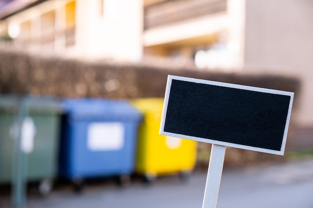 Empty mockup template blackboard label against color container for separate collecting garbage recyc