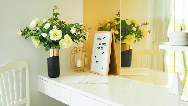 Empty modern white dressing table makeup place with mirror in yellow color tone bedroom