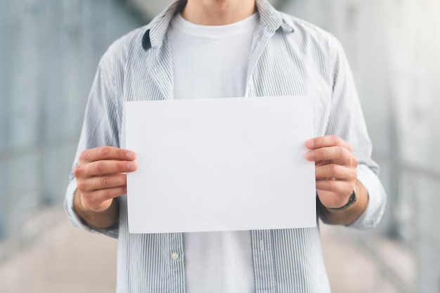 Empty name board in hands of meeting man at airport