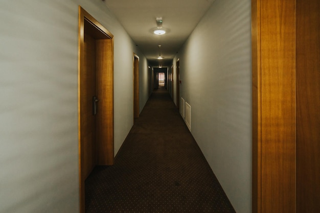 Empty narrow long hotel corridor