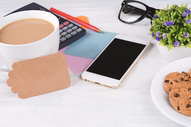 Empty note paper with coffee, cookies and calculator