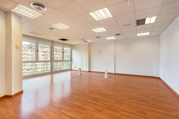 Empty office and fluorescent lamps on the ceiling in need of repair and replacement bright office