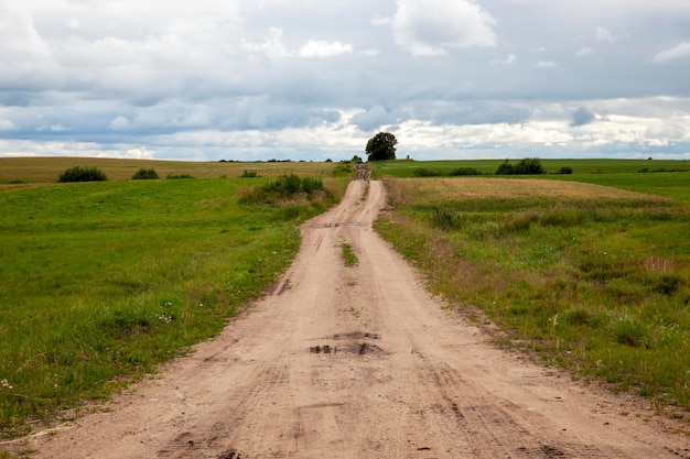 An empty old not paved road road markings on an not asphalt highway