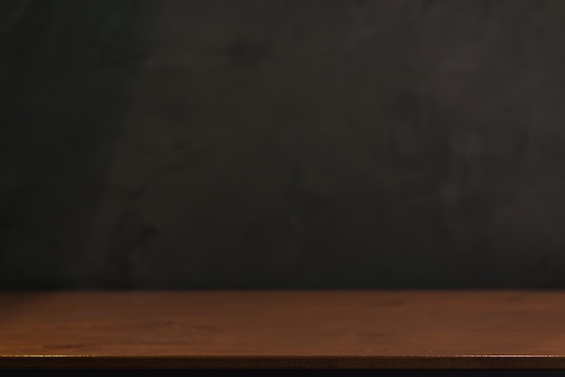 Empty old tabletop in front of blurred blank Blackboard Background in class room