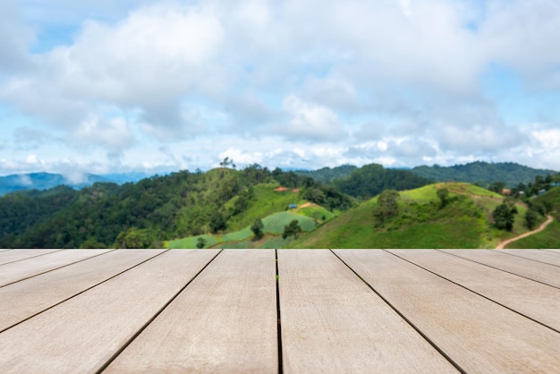 Empty old wooden table in front of blurred mountain and clear blue sky background Can be used for display or montage for show your products