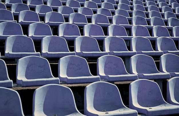 Empty outdoor arena concept of fans chairs for audience cultural environment concept color and symmetry empty seats modern stadium blue tribunes seats of tribune on sport stadium