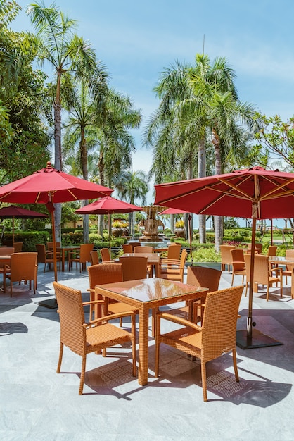 empty outdoor patio table and chair with umbrella