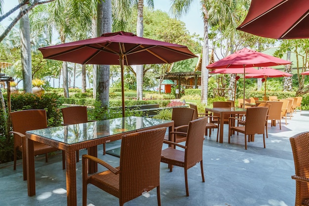 empty outdoor patio table and chair with umbrella