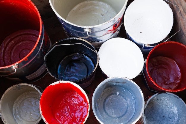 Empty paint buckets with drips top view