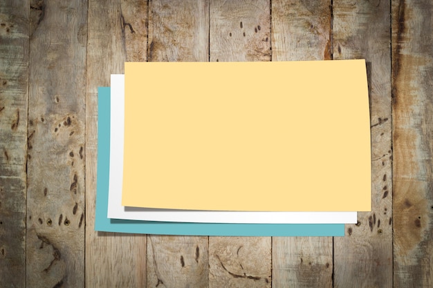 Empty papers on Wooden texture background.