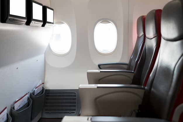 Empty passenger airplane seats in cabin. Interior in modern airplane.