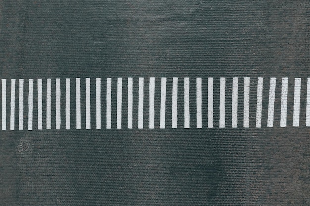 Empty pedestrian crossing on the road of paving stones top view