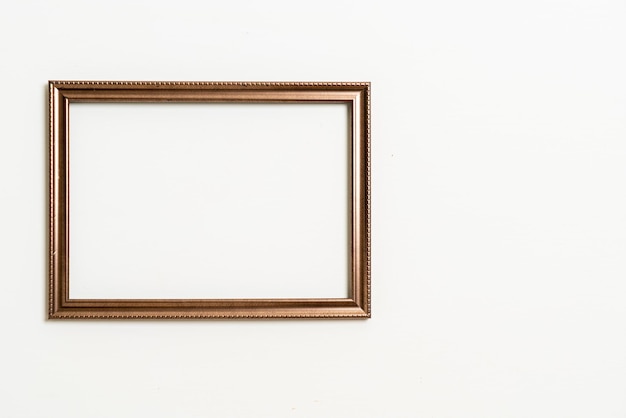 empty picture frame on white wall background with copy space