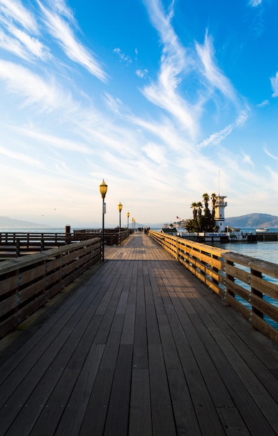 Empty pier over sea against sky