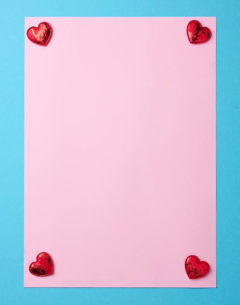 Empty pink paper sheet on blue background