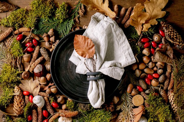 Empty plate over ambiance magic autumnal forest background