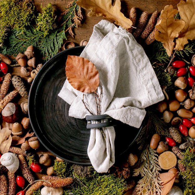 Empty plate over ambiance magic autumnal forest background