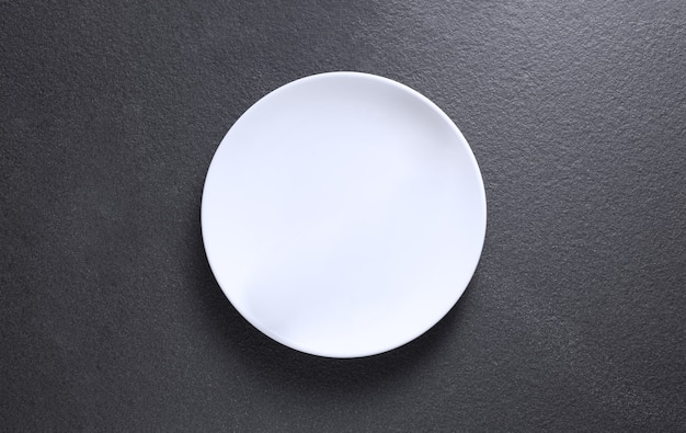 Empty plate on gray table, top view