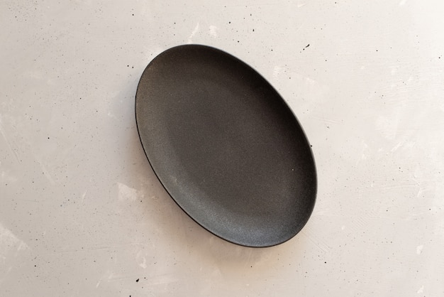 Empty plate on grey wooden table