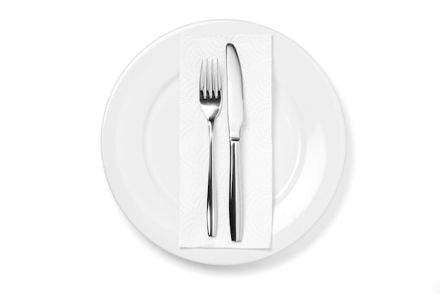 Empty plate with knife and fork isolated on a white background