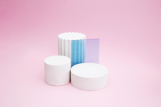 Empty podium for product display Cylindrical white scene pedestal with glass on pink background Minimal style