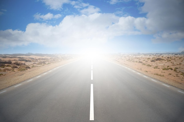 Empty road on a desert with cloudy sky