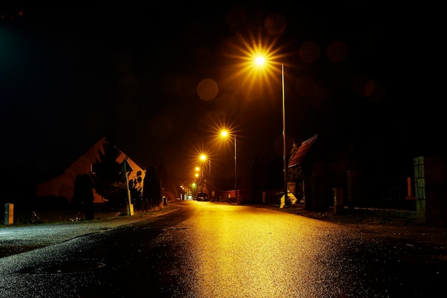 Empty road at night with street lights