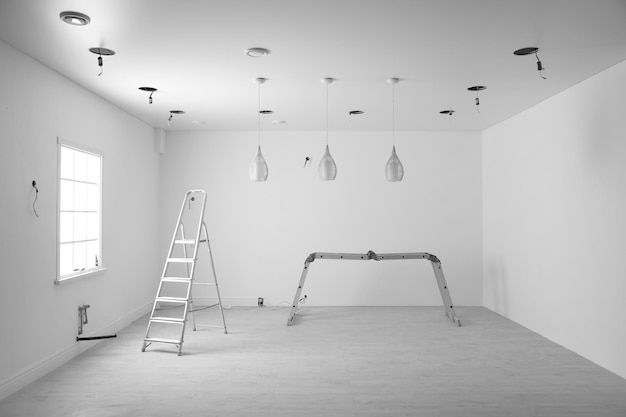 Empty room with stretch ceiling and ladders