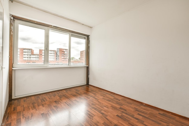 Empty room with white walls and parquet floor