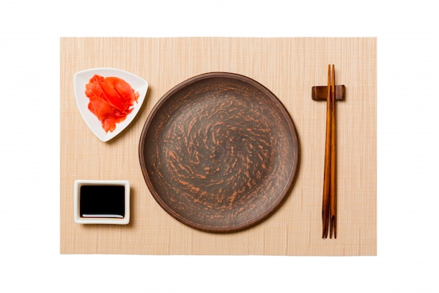 Empty round gray plate with chopsticks