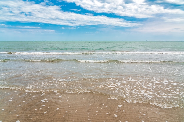 Empty sandy sea beach with small waves