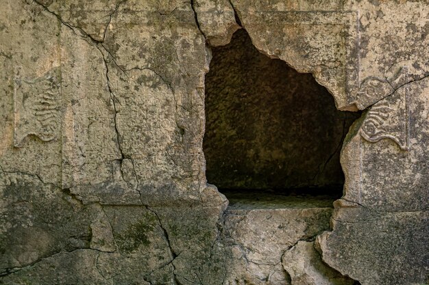 Empty sarcophagus with a hole in the wall in the ruins of the antique city of Olympos in Turkey