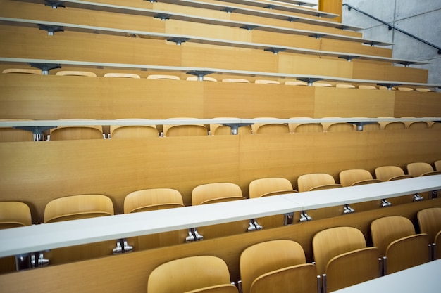 Empty seats with tables in a lecture hall