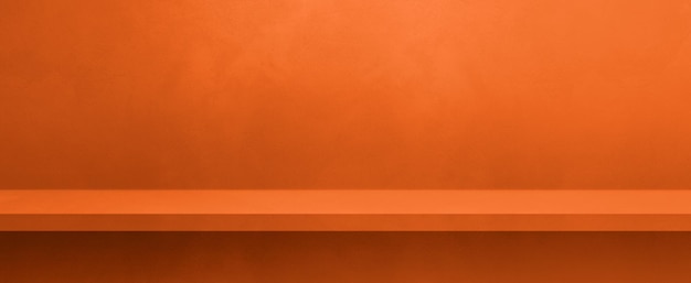 Empty shelf on a neon orange concrete wall Background template Horizontal banner mockup