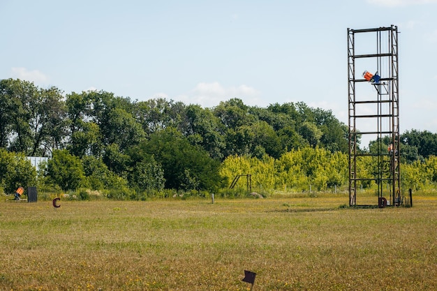 Empty shotgun training field with green grass and plat machines