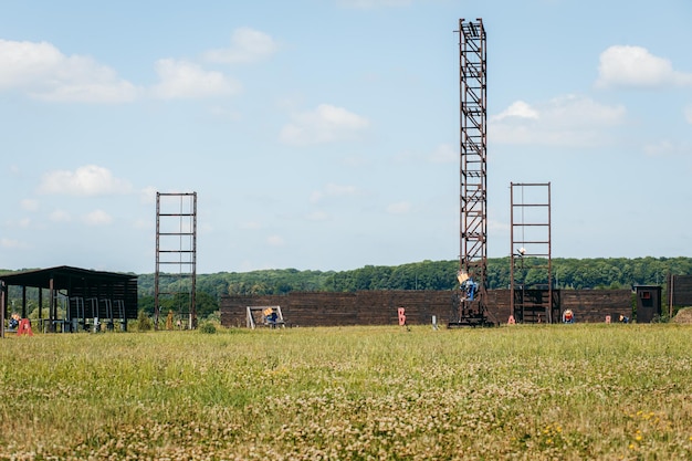 Empty shotgun training field with green grass and plat machines