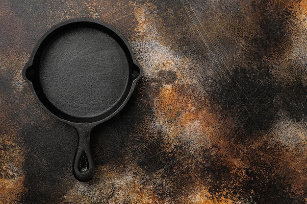 Empty skillet, frying pan set with copy space for text or food with copy space for text or food, top view flat lay, on old dark rustic table background