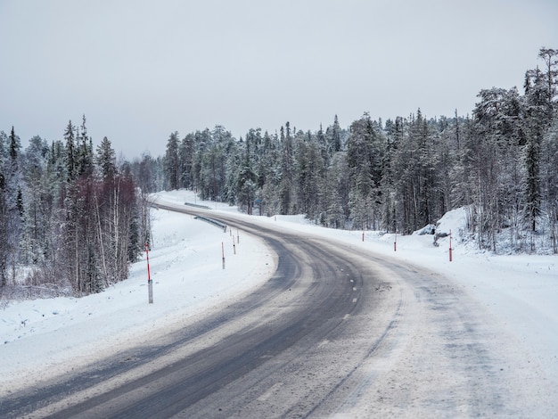 Empty snowy Northern winter road, turn on the road.