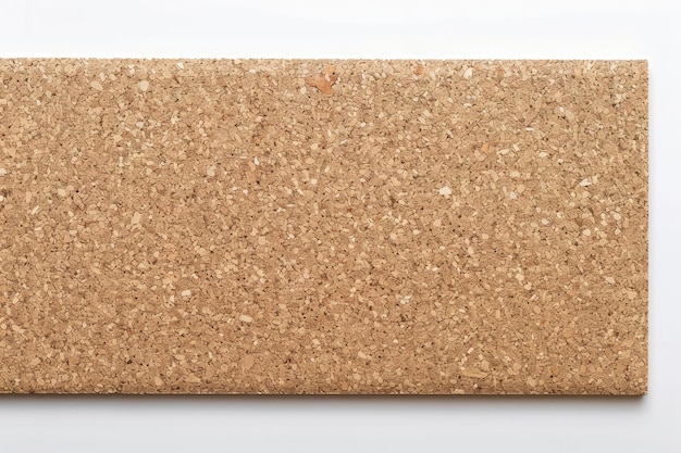 Photo empty space on cork board isolated on white background