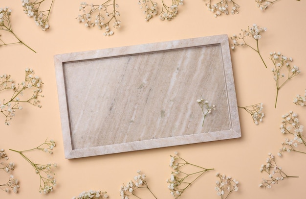 Empty square plate on beige background top view