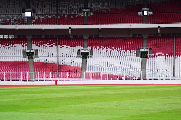 Empty stadium background with a green grass