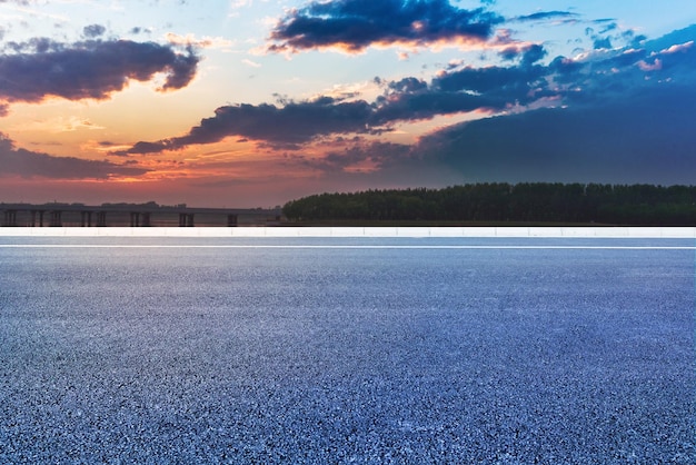 An empty straight highway in the sunset