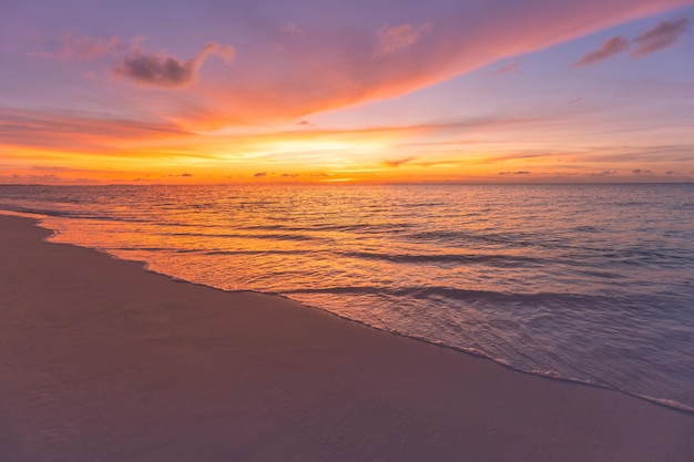 Empty sunset beach Idyllic tropical beach landscape for background or wallpaper Soft waves splash