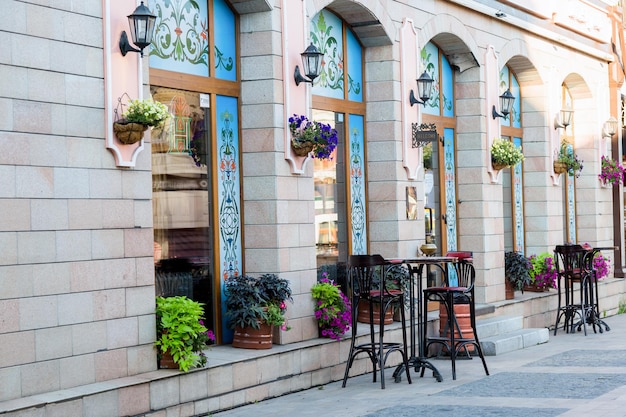 Empty tables of a street cafe in a European city are waiting for visitors