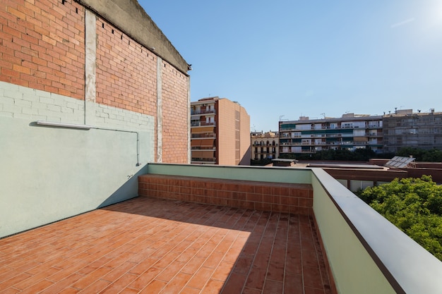 Empty terrace on the roof of modern building in barcelona spain view to the city and blue sky on sun...