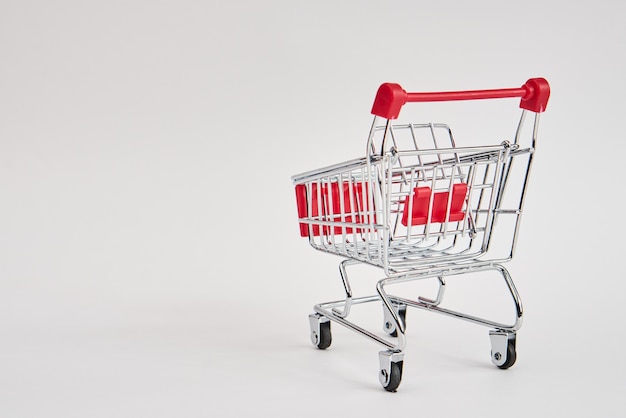 empty trolley on light background shopping supermarket service. High quality photo